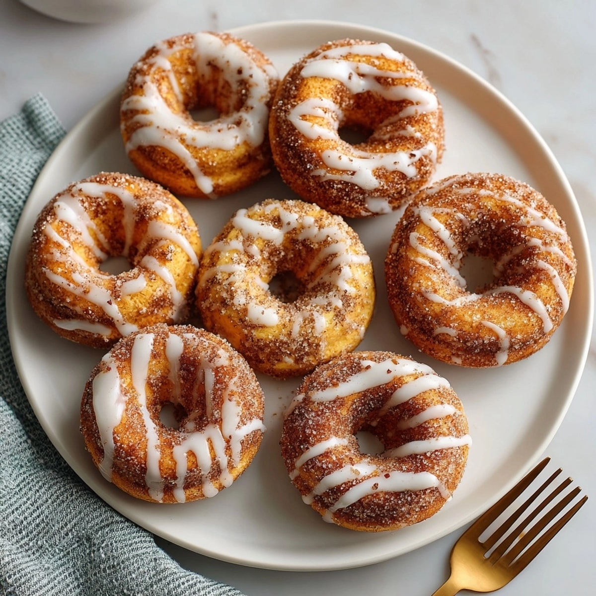 Homemade Spiced Pumpkin Mini Donuts on a rustic platter; a delicious, comforting autumn dessert.
