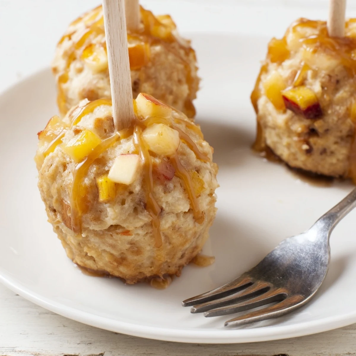 Delicious bites of apple and cheddar in Maple Bourbon Biscuit Muffin Pops, perfect for brunch.  