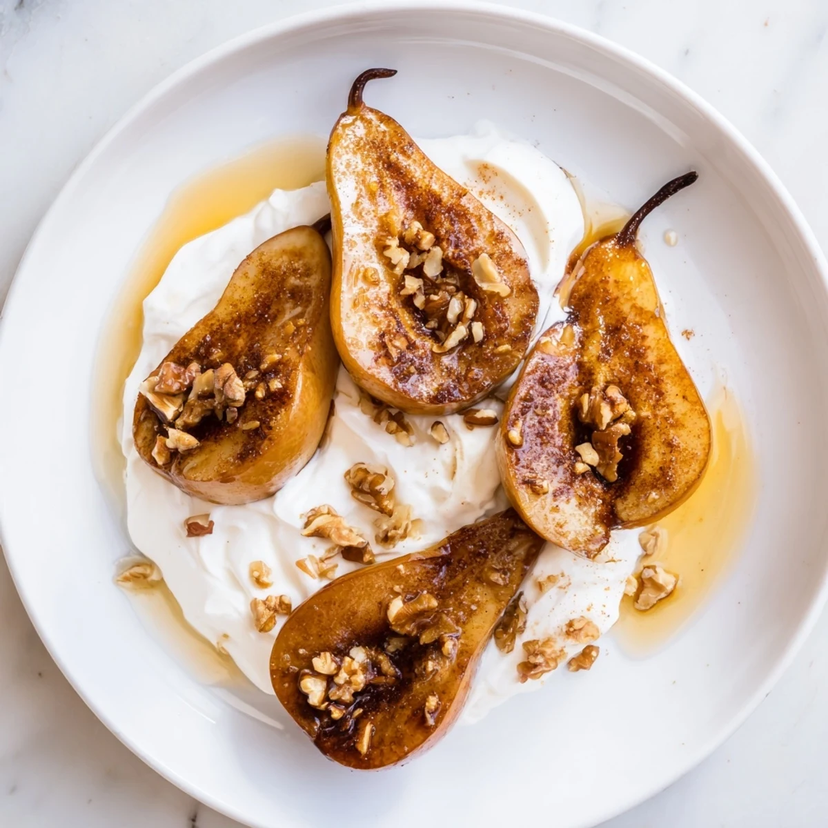 Enjoy sweet and spiced roasted pears with crunchy walnuts, a simple dessert for your enjoyment.