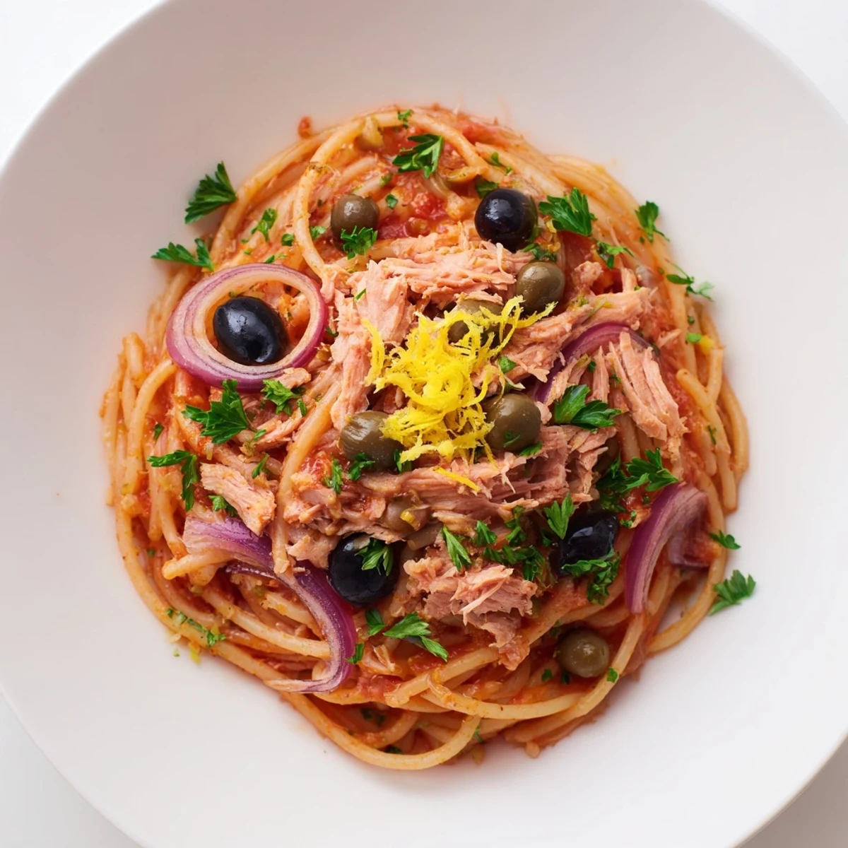 Flaky tuna and briny olives adorn this flavorful pasta with tuna, olives, and capers dish.