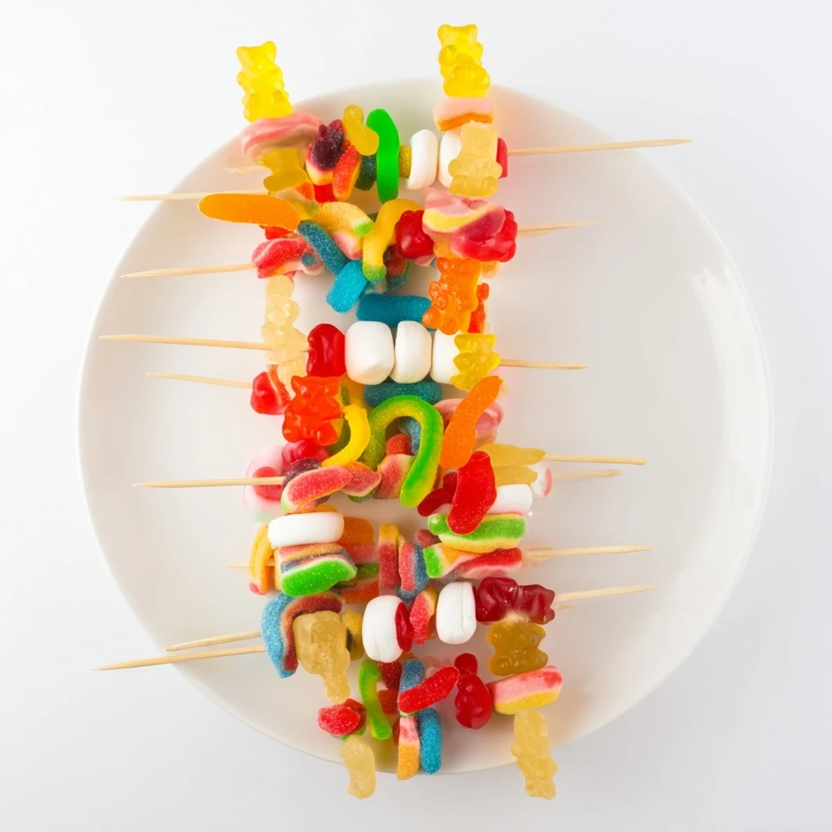 Bright, colorful gummy candy kabobs with an assortment of sweet treats, perfect for kids' parties.