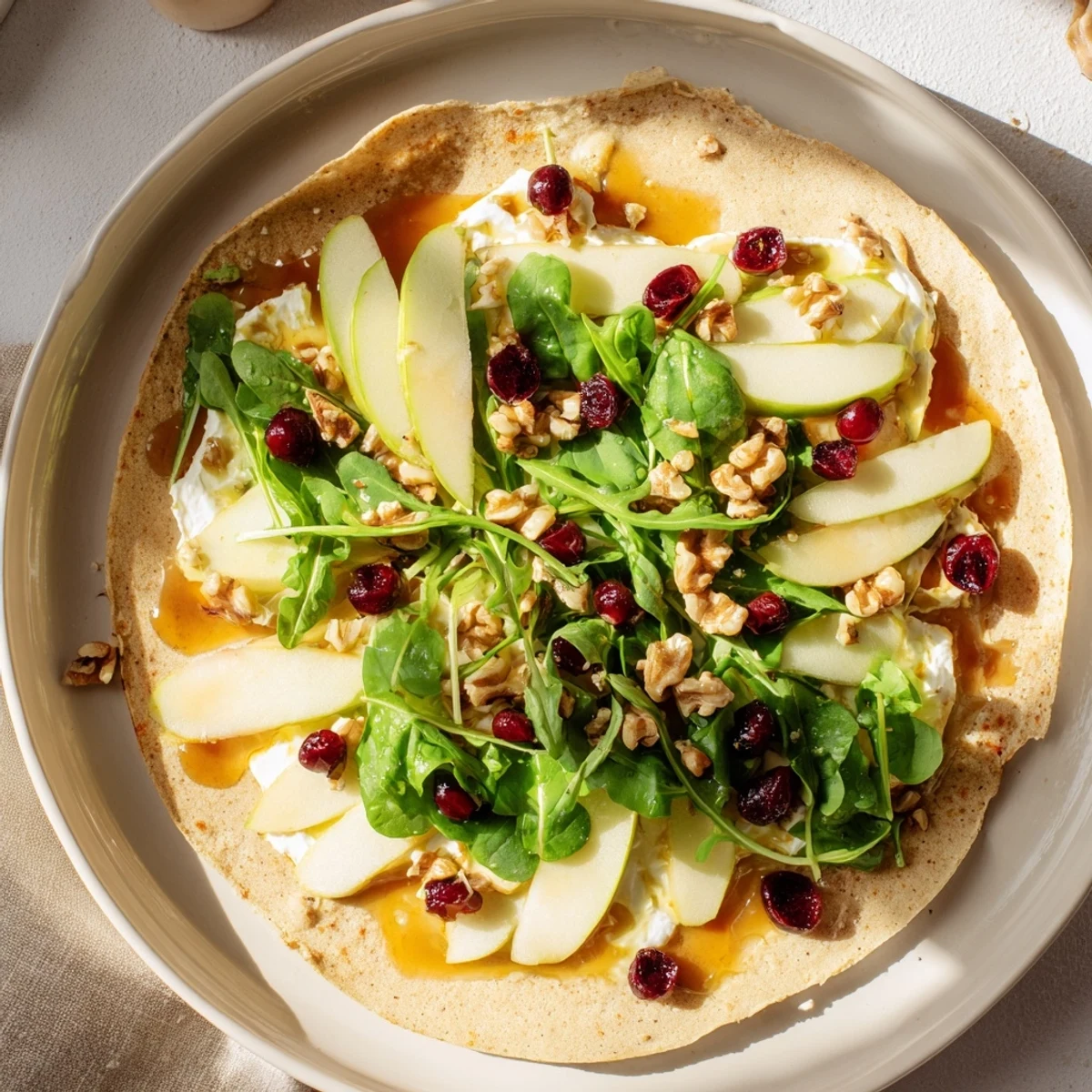 Serving suggestion: Slice into festive halves to enjoy flavorful Cranberry Goat Cheese & Walnut Wraps.