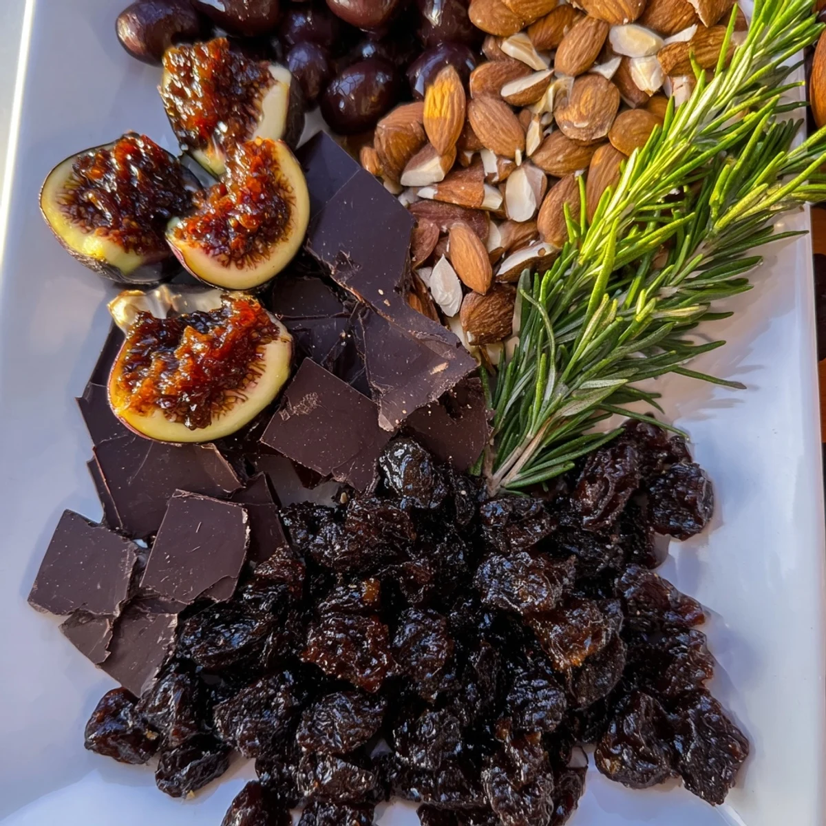 A Winter Solstice Board overflowing with olives, figs, Brie, and pears, perfect to serve.