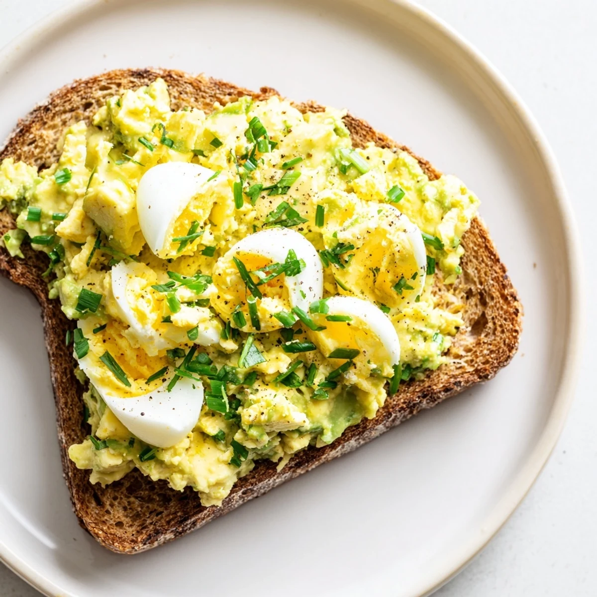 Hearty whole-grain toast topped with Avocado Egg Smash, ideal for a quick and easy lunchtime meal.