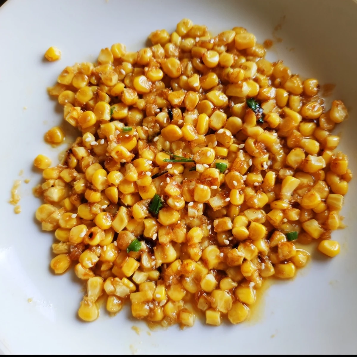 Golden Japanese Butter Corn glistening in a skillet just after cooking, ready to serve and enjoy.
