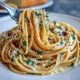 Bright and tangy lemon butter pasta dish featuring al dente spaghetti coated in rich, glossy sauce, perfect for quick vegetarian dinners.