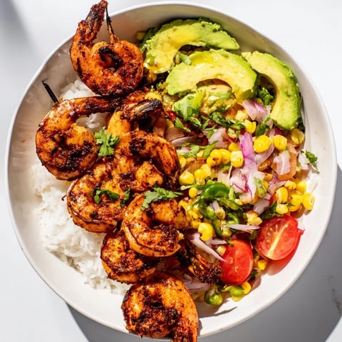 A colorful overhead shot of a delicious Easy Grilled Shrimp Bowl with Avocado Corn Salsa.