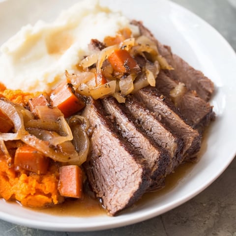 Tender Classic Brisket and Mashed Sweet Potatoes, served with savory gravy and beautiful fall colors.