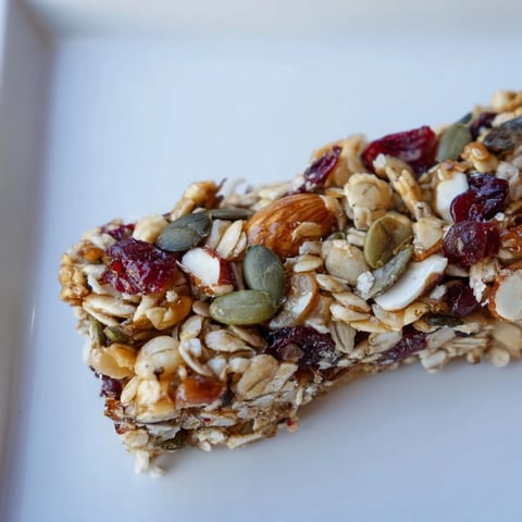 Golden-brown roasted pumpkin seed & cranberry granola bars, perfect for a quick and healthy breakfast.
