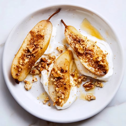 Warm, caramelized roasted pears with cinnamon, walnuts, and Greek yogurt make a delicious dessert.