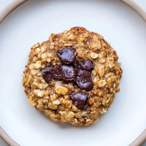 Warm, golden Oat-Banana Chocolate Chip Cookies fresh from the oven, offering a tempting aroma.