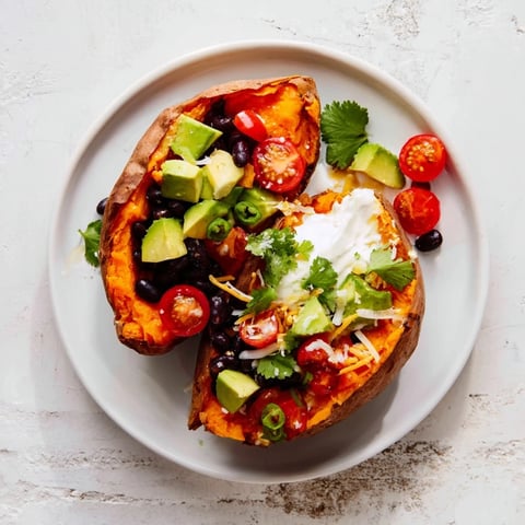 Golden brown Loaded Baked Sweet Potatoes, brimming with flavorful black beans and fresh toppings, ready to enjoy.