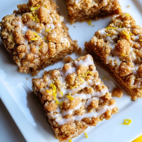 Golden, crumbly Lemon-Glazed Gingerbread Crumble Bars, drizzled with bright, tangy lemon glaze, delicious.