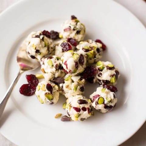 Creamy Matcha White Chocolate Cranberry Bark Clusters, studded with bright red cranberries, ready to enjoy.