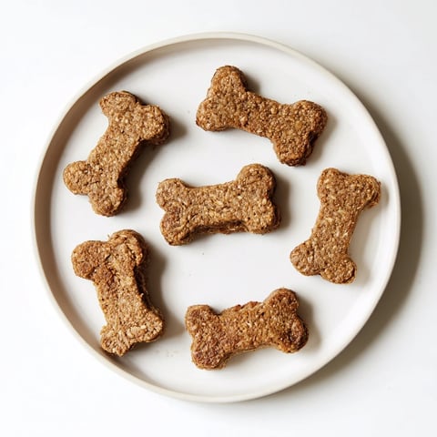 Golden, baked Pawsitively Good Dog Bone Treats, ready and crunchy, perfect for your pup's delight.
