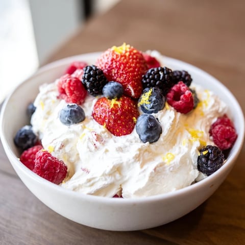 Fluffy Cream Cheese Fruit Dip artfully arranged with vibrant, juicy berries for dipping pleasure.