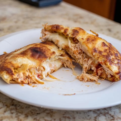 Golden-brown Leftover Pizza Grilled Cheese with melted cheese oozing from a perfectly toasted crust.