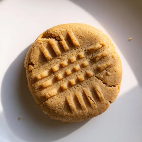 Tempting close-up of golden-brown flourless peanut butter cookies ready to eat.