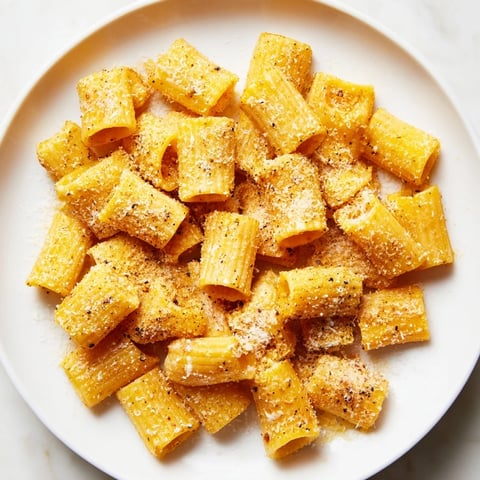 Golden, crispy pasta chips with Parmesan cheese, perfect for dipping and snacking on.