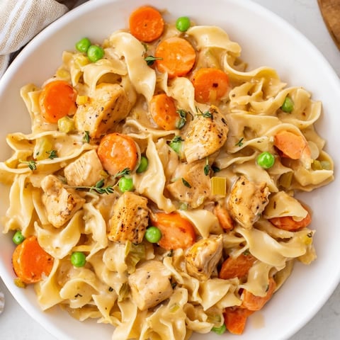Creamy Chicken and Egg Noodles: A comforting, steaming bowl filled with a savory chicken and noodle dish.