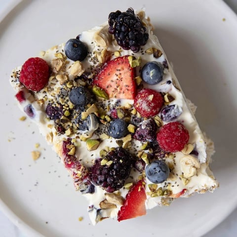 A vibrant photo of Frozen Fruit Yogurt Bark, a berry-speckled, frozen summer treat.