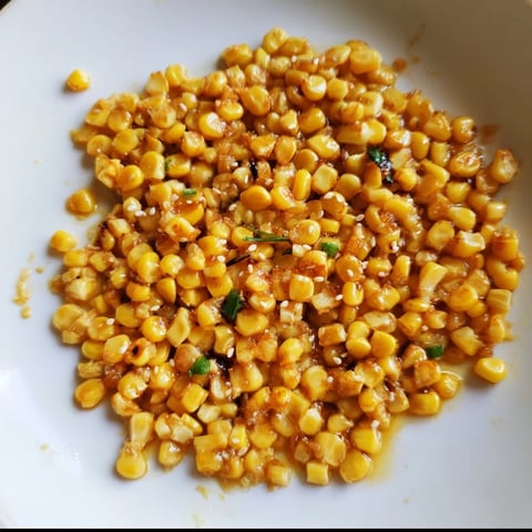 Golden Japanese Butter Corn glistening in a skillet just after cooking, ready to serve and enjoy.