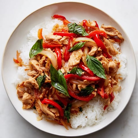 Steaming Thai Basil Chicken Bowls with fresh basil garnish, ready to eat and enjoy.