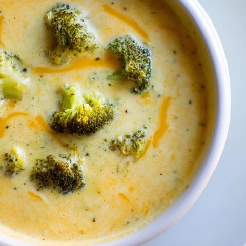 Creamy Broccoli Cheddar Soup, garnished with roasted florets, ready to be served hot.