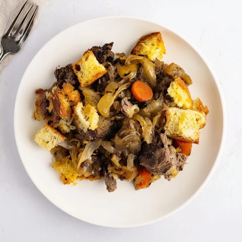 A close-up of a comforting French Onion Pot Roast Casserole showcasing tender beef and crusty bread.