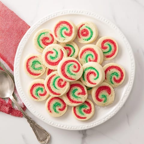 Freshly baked Holiday Pinwheel Cookies offer a buttery taste, with swirled red and green dough.
