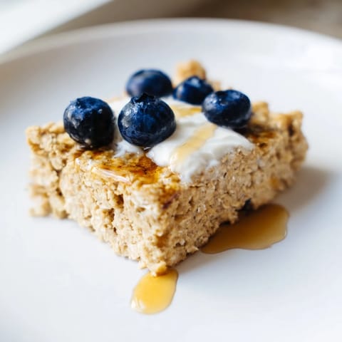 Warm, appetizing Protein Pancake Oats, topped with fresh blueberries, a protein-packed morning meal.