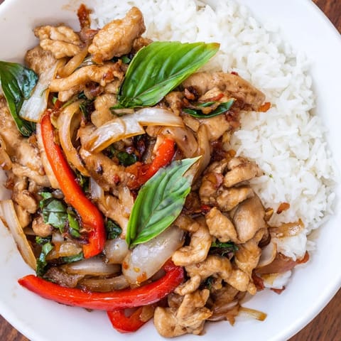 Aromatic Thai Basil Chicken Bowls with tender chicken and fluffy rice, ready to eat.