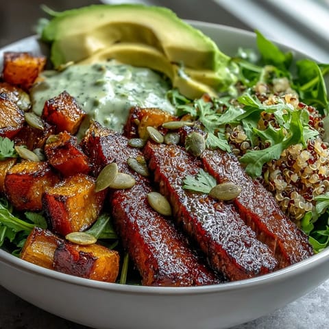 A vibrant butternut squash steak bowl with fluffy quinoa, avocado, and smoky steak slices.
