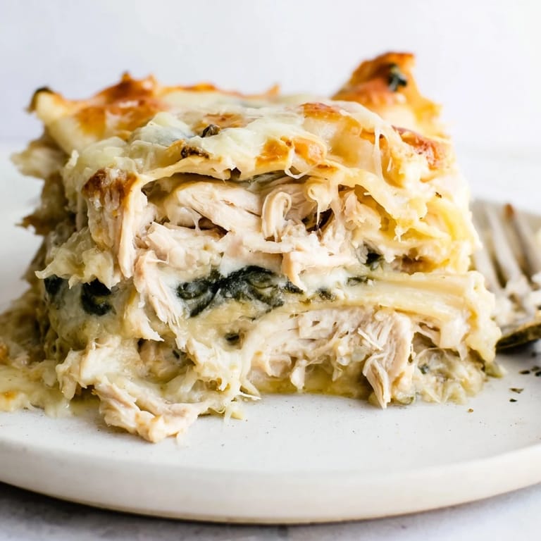 Homemade rosemary chicken lasagna, golden and fragrant, is the ultimate comfort meal.  