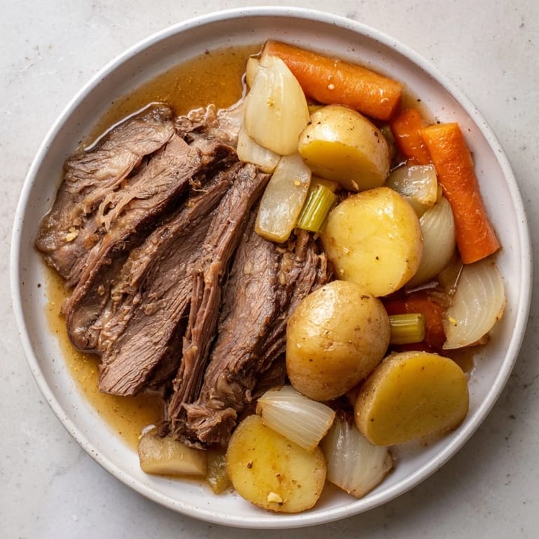 A close-up of a steaming Sunday Pot Roast, showcasing juicy meat and colorful roasted vegetables.