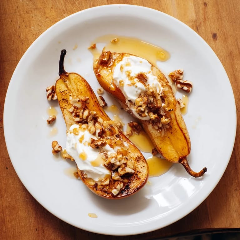 A beautiful photo displaying oven-roasted pears sprinkled with cinnamon, served with Greek yogurt.